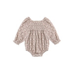 A baby long-sleeve romper with a dense beige and brown floral pattern, featuring a smocked bodice and ruffled sleeves, shown flat on a white background.