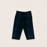 A pair of dress pants in navy and green plaid laid flat on a white background.