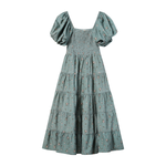 A sage green tiered maxi dress with a small floral print, featuring puff sleeves and a smocked bodice, shown against a plain white background.