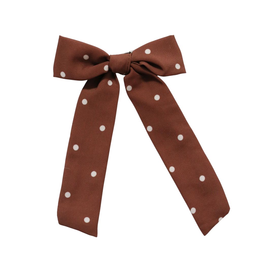 A brown fabric bow tie with white polka dots, presented on a clean white background.