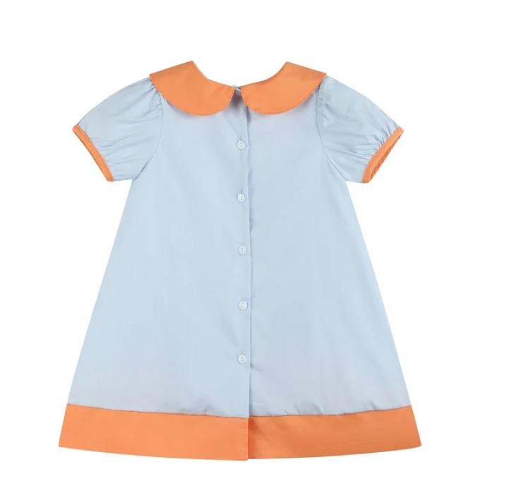 A short-sleeve baby dress in light blue with orange trim on the collar, sleeve cuffs, and bottom hem, featuring a button-up front.