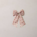Floral bow on a light gray background