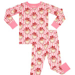 A two-piece children's pajama set featuring a pink and white striped pattern with cartoon monkey faces wearing red bows, complete with solid pink cuffs and collar.