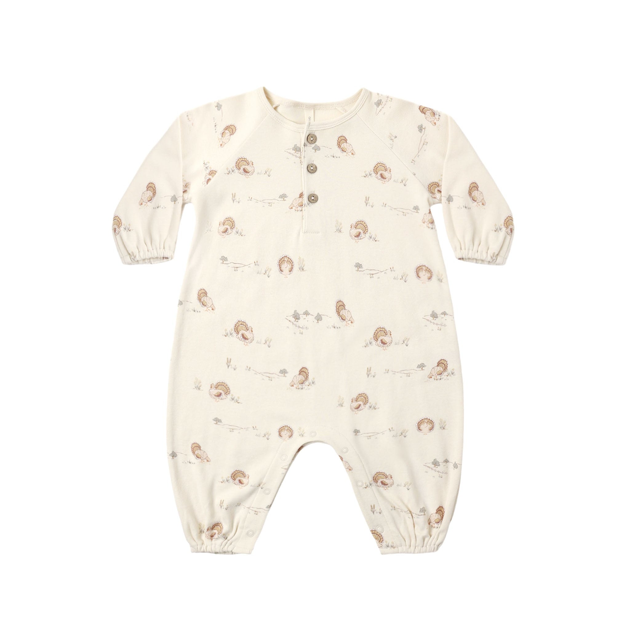 A baby long-sleeve footless romper in cream with a small brown and beige animal print, featuring a snap-button henley neckline and elastic cuffs.