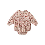 A baby long-sleeve romper in a beige and brown floral print with red accents, featuring a Peter Pan collar, smocked chest, and elastic leg cuffs, shown flat on a white background.