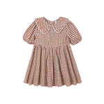 A toddler girl's short-sleeve dress in a brown and white gingham check pattern, featuring a large Peter Pan collar with white lace trim, a gathered waist, and a flared skirt.