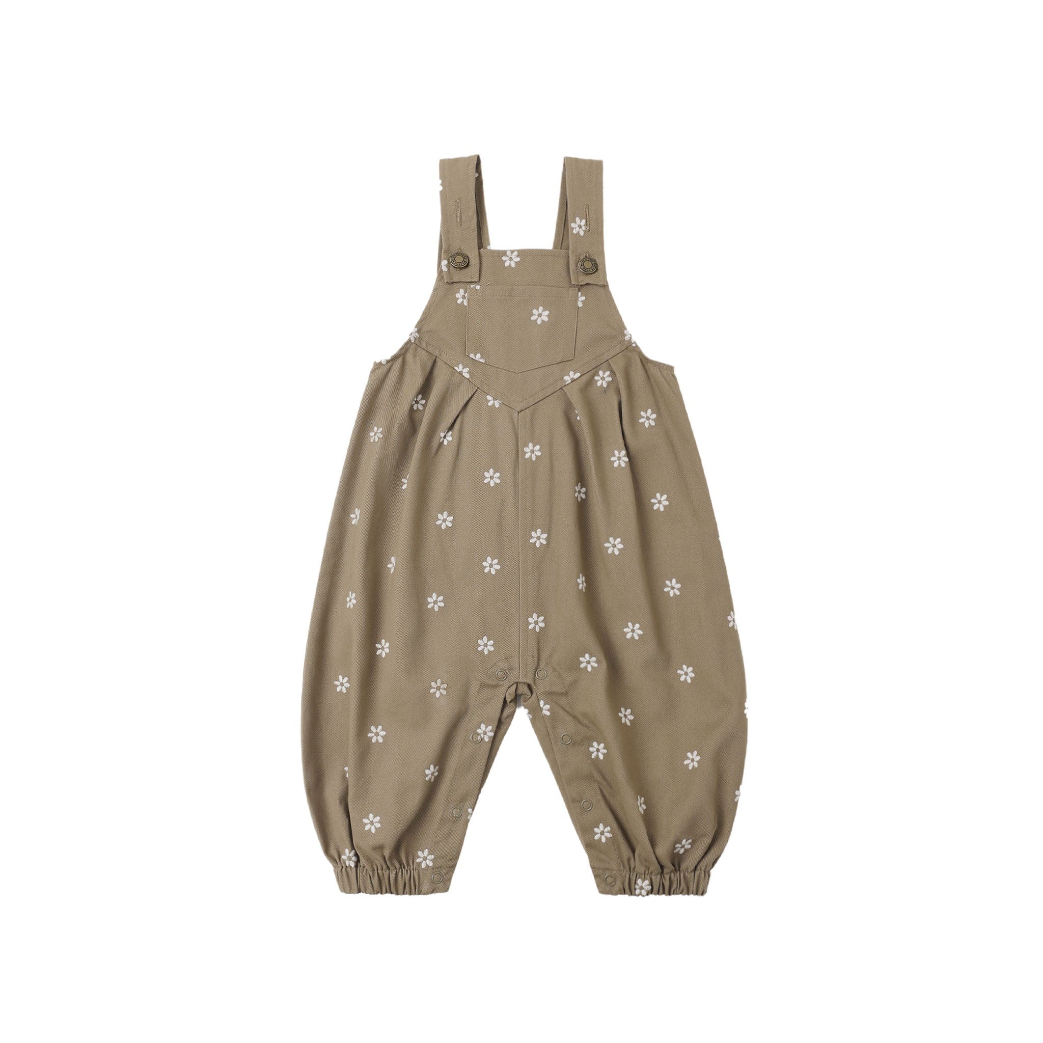A pair of toddler's overall-style romper pants in a warm taupe-brown color, decorated with a small white floral pattern, shown against a plain white background.