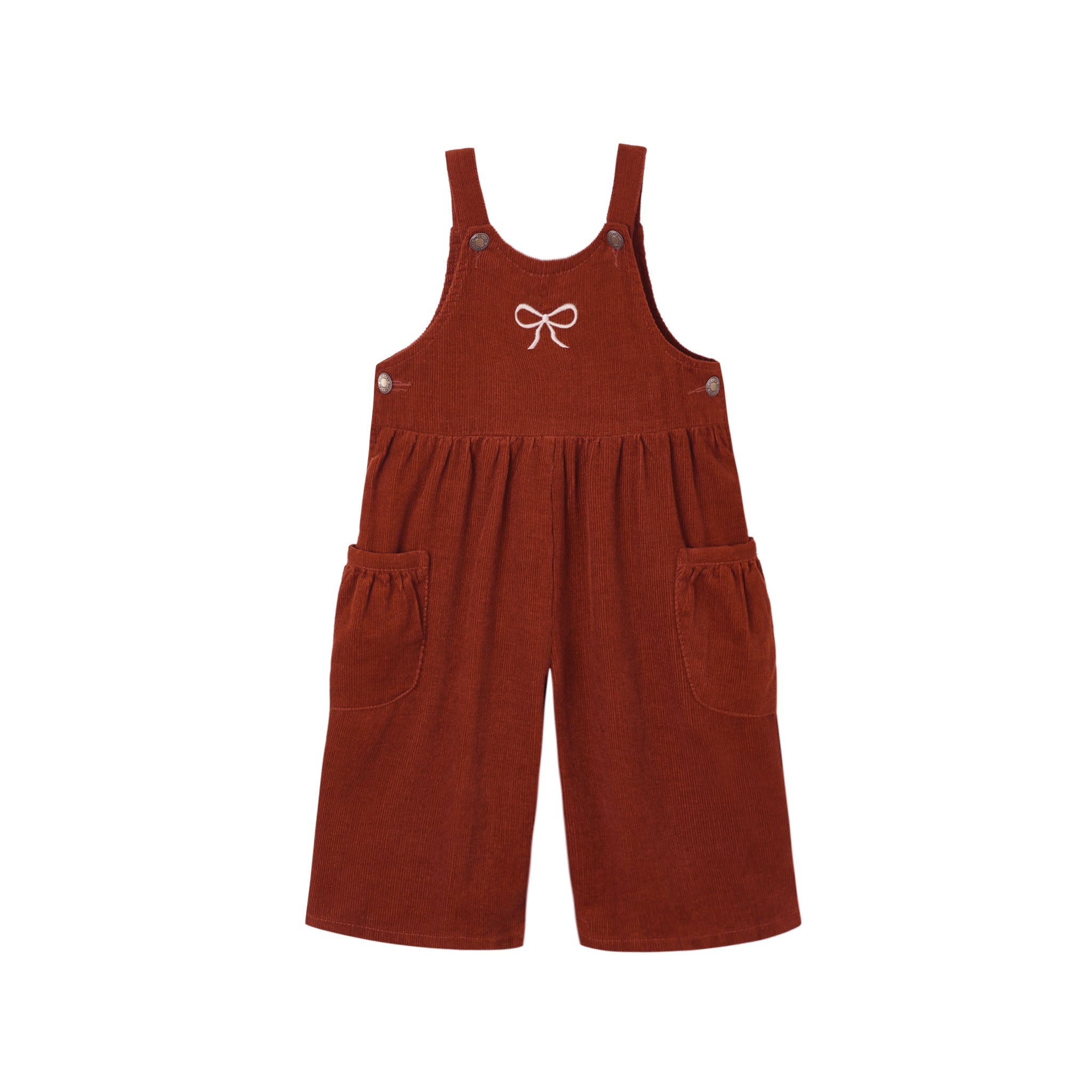 A rust-colored corduroy short overall romper with adjustable shoulder straps, side pockets, and a small white bow embroidered on the chest, shown against a plain white background.