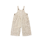A baby's short overall jumpsuit with a beige and brown leopard print pattern, featuring adjustable shoulder straps with buttons and side pockets, shown on a plain white background.