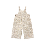 A baby's short overall jumpsuit with a beige and brown leopard print pattern, featuring adjustable shoulder straps with buttons and side pockets, shown on a plain white background.
