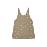 A sleeveless brown vest with a white daisy pattern, featuring a button-up front and two front patch pockets, shown flat on a white background.
