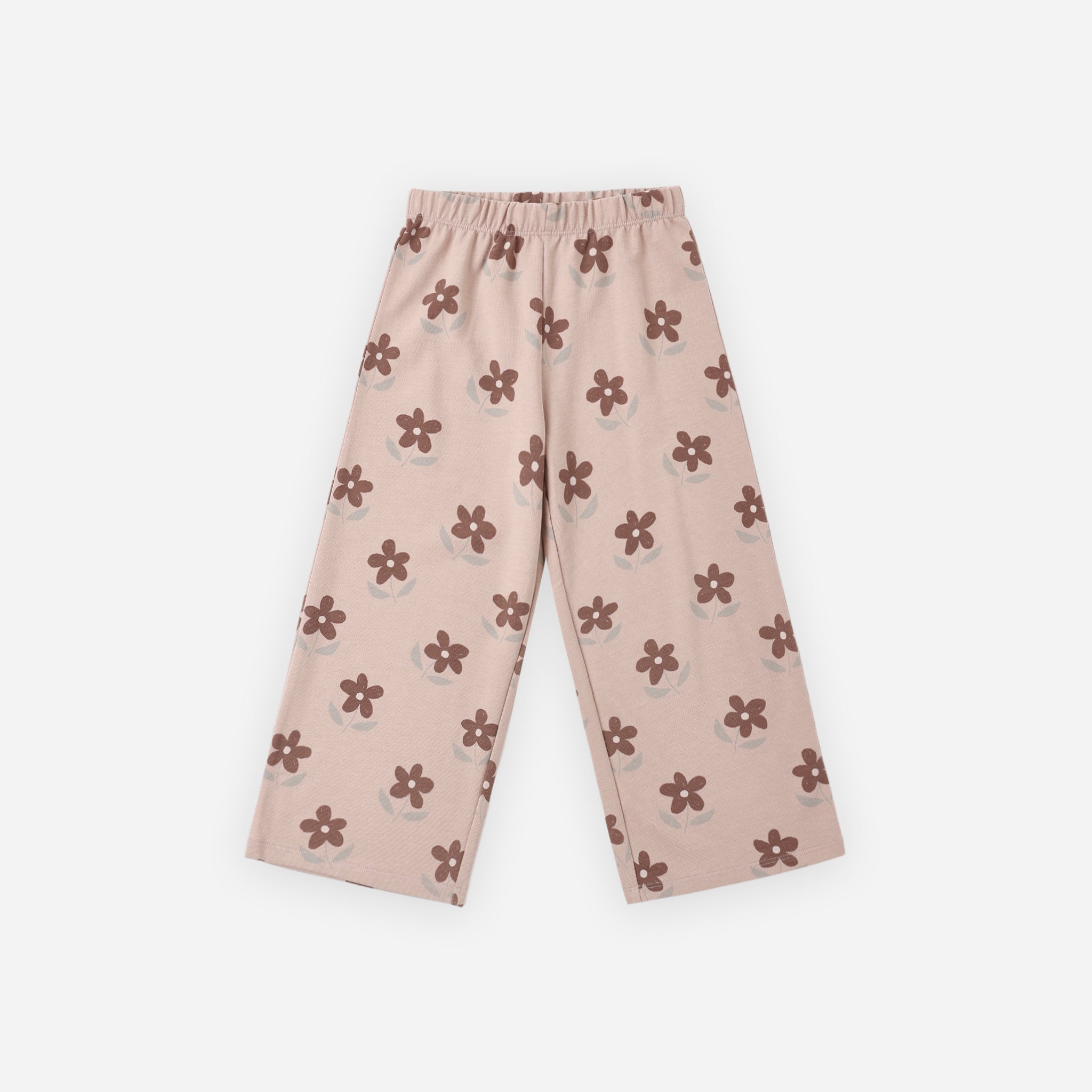 A pair of children's cropped pants in a dusty pink color, featuring an all-over print of small brown flower motifs, laid flat against a light gray background.