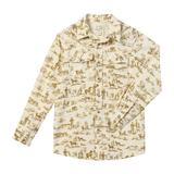 A long-sleeve button-up shirt for kids, featuring a warm cream base with a brown toile-style print depicting farm and country scenes. The shirt has a classic collar, button-down front, and two chest pockets.