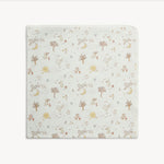 A square baby blanket with rounded corners, featuring a delicate woodland pattern of trees, squirrels, rabbits, and moons on an off-white background.