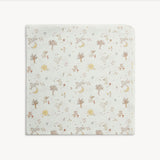 A square baby blanket with rounded corners, featuring a delicate woodland pattern of trees, squirrels, rabbits, and moons on an off-white background.