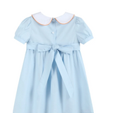 A light blue short-sleeve girl's dress with a white Peter Pan collar outlined in orange, featuring a button front, a matching waist tie bow, and a flared skirt.
