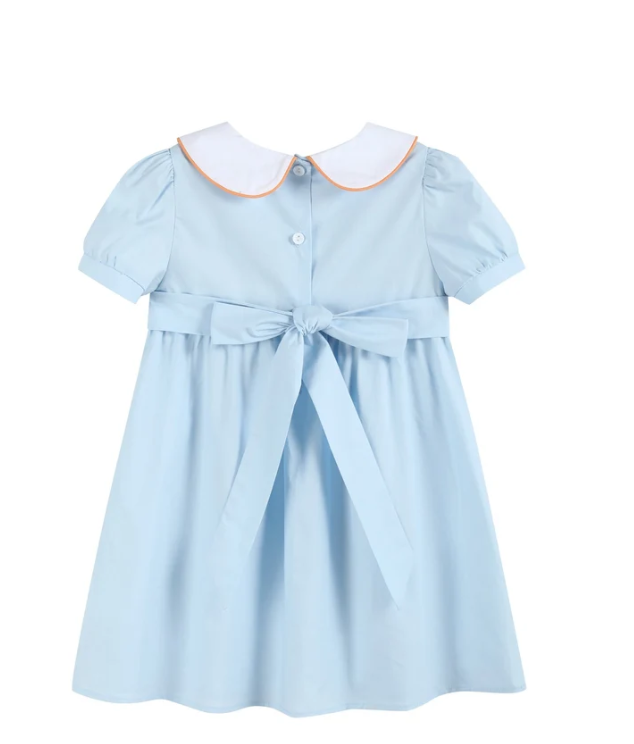 A light blue short-sleeve girl's dress with a white Peter Pan collar outlined in orange, featuring a button front, a matching waist tie bow, and a flared skirt.