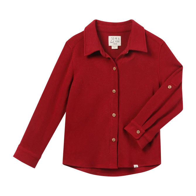 A red long-sleeve button-up shirt with a pointed collar and gold-tone buttons, laid flat on a white background.