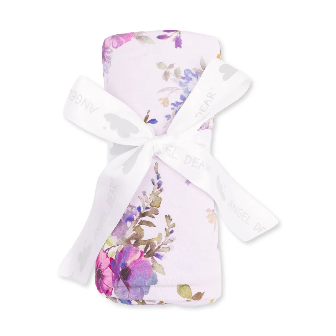 A folded baby blanket with a watercolor floral pattern in pink, purple, and green on a pale pink background, tied with a white ribbon printed with the brand name 'Angel Dear'.