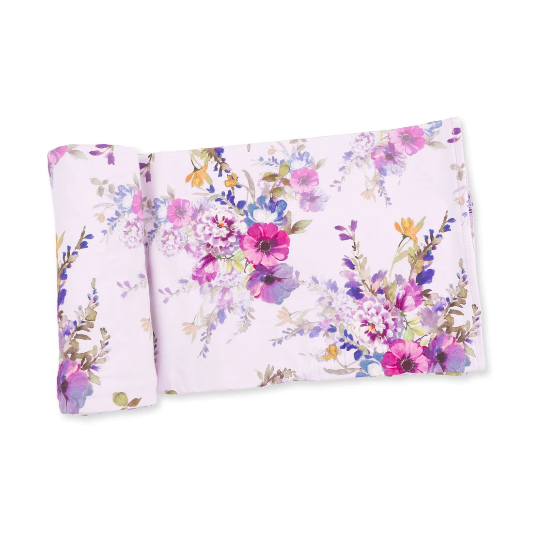 A folded blanket, featuring a colorful watercolor floral pattern with pink, purple, blue, and green tones, set against a plain white background.