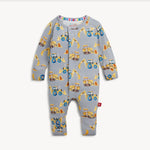 A baby long-sleeve footless one-piece romper in light gray, featuring an all-over print of yellow construction vehicles including tractors, excavators, and bulldozers. The romper has a snap closure down the front and ribbed cuffs on the sleeves and legs.