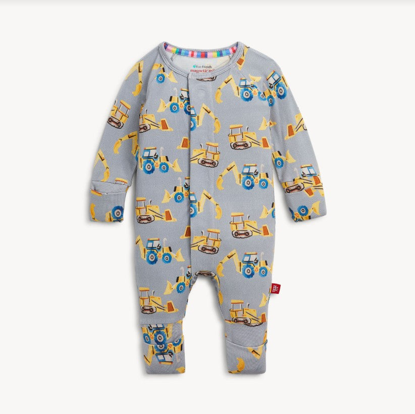 A baby long-sleeve footless one-piece romper in light gray, featuring an all-over print of yellow construction vehicles including tractors, excavators, and bulldozers. The romper has a snap closure down the front and ribbed cuffs on the sleeves and legs.