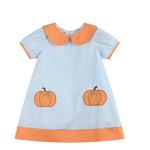 A short-sleeve baby dress in light blue with an orange Peter Pan collar, orange sleeve trim, an orange hem, and two embroidered orange pumpkins on the front.