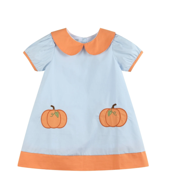 A short-sleeve baby dress in light blue with an orange Peter Pan collar, orange sleeve trim, an orange hem, and two embroidered orange pumpkins on the front.