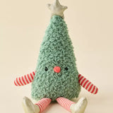 A plush Christmas tree toy with a textured mint green body, red and white striped arms and legs, a small red nose, and a gold star on top, sitting against a solid beige background.