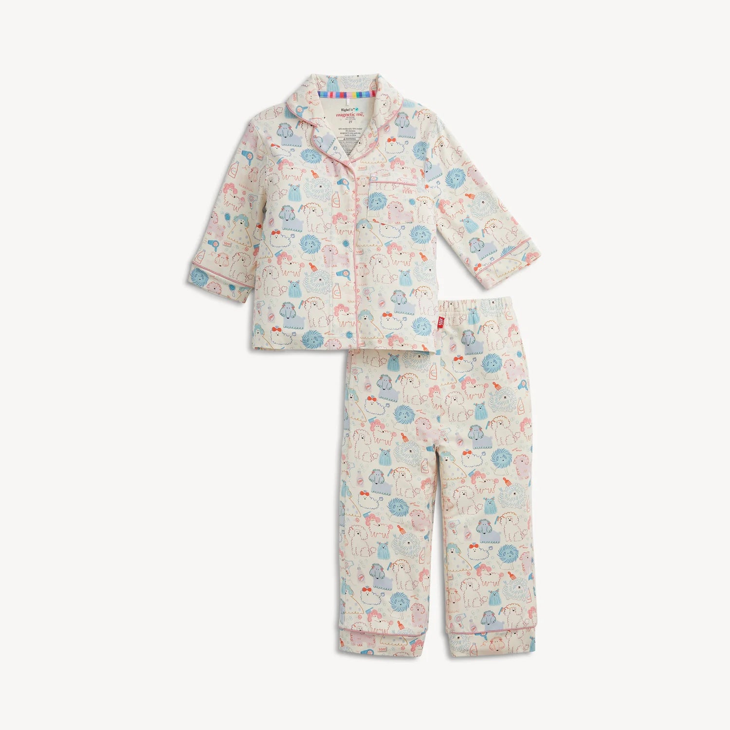 A two-piece children's pajama set featuring a long-sleeve button-up top and matching pants, both printed with a whimsical cartoon pattern in light blue, pink, and yellow on a cream background.