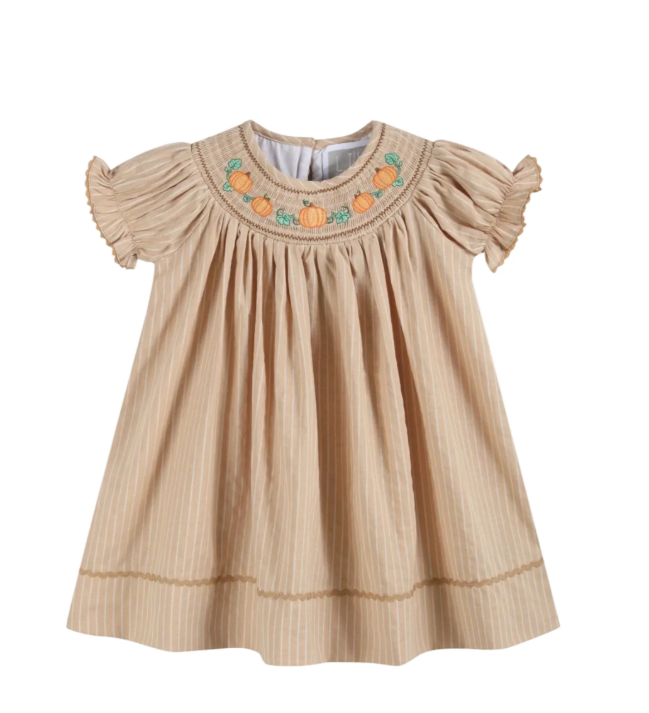 A beige baby girl's dress with vertical stripes, ruffled short sleeves, and a smocked neckline decorated with embroidered orange pumpkins and green leaves, shown on a plain white background.